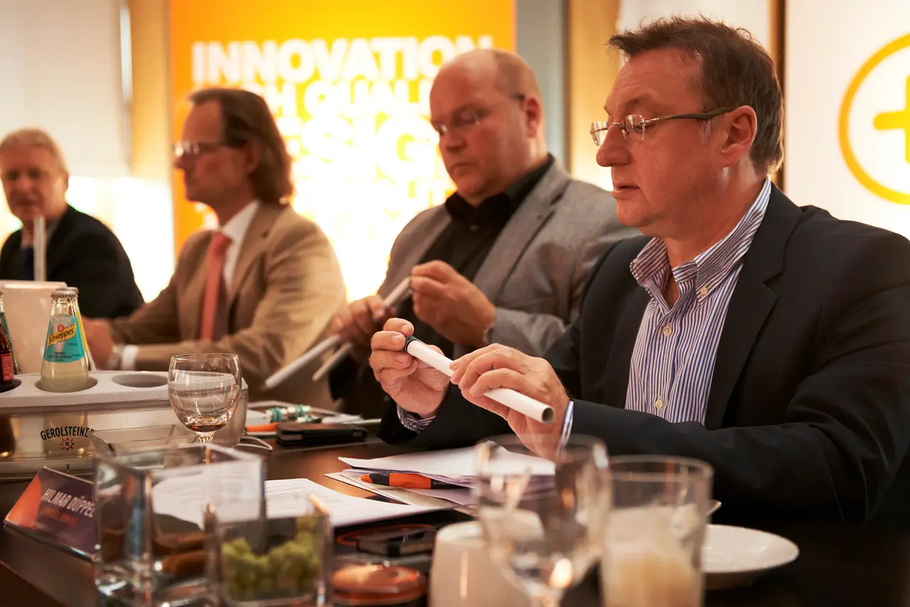 The jury at the table, a sample passed from hand to hand