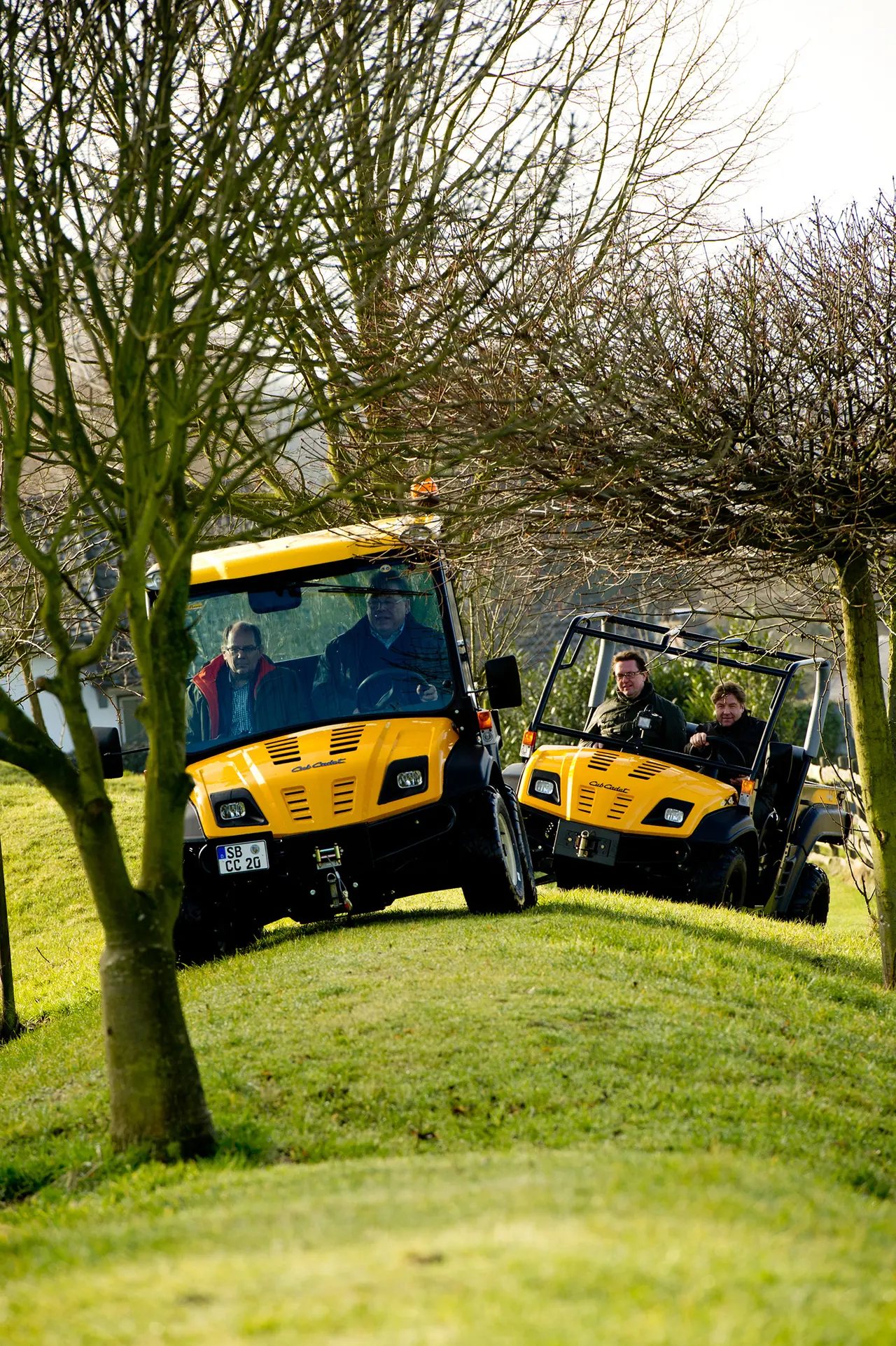 Two utility vehicles driven across the lawn