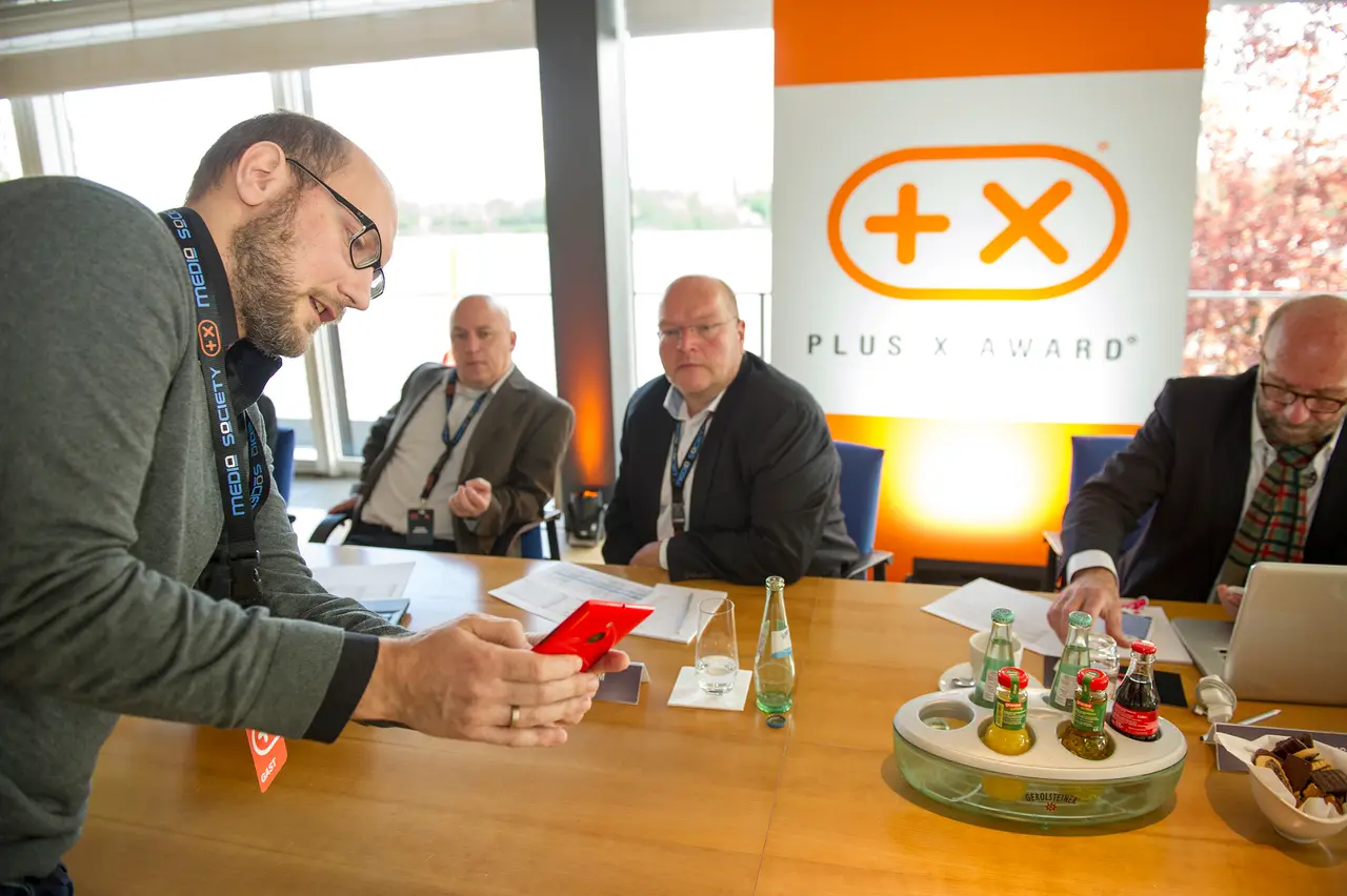 A mobile phone is passed round and examined