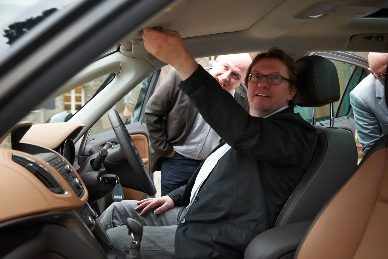 A juror examines a vehicle from the inside