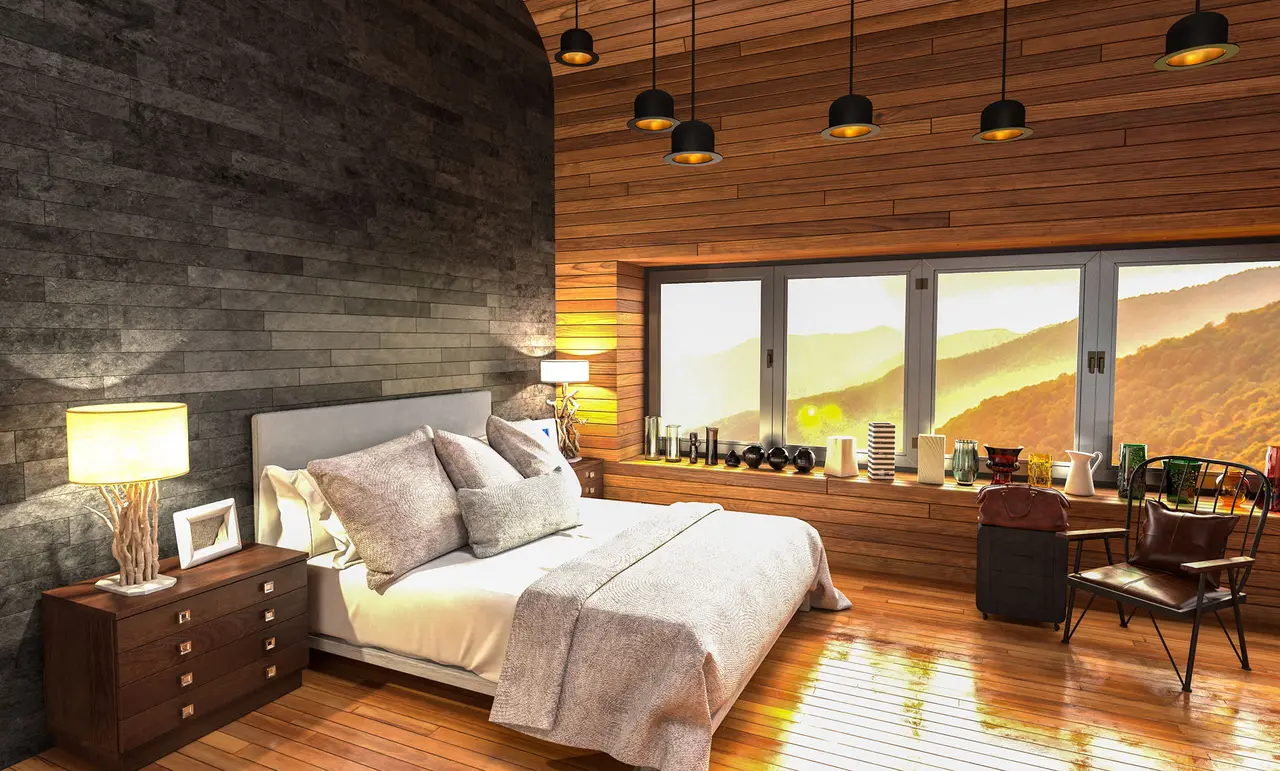 Gemütliches Hotelzimmer mit Holzwänden, Doppelbett und Blick auf Berge im Abendlicht
